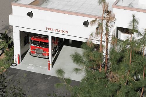 A fire station with a truck parked in it.