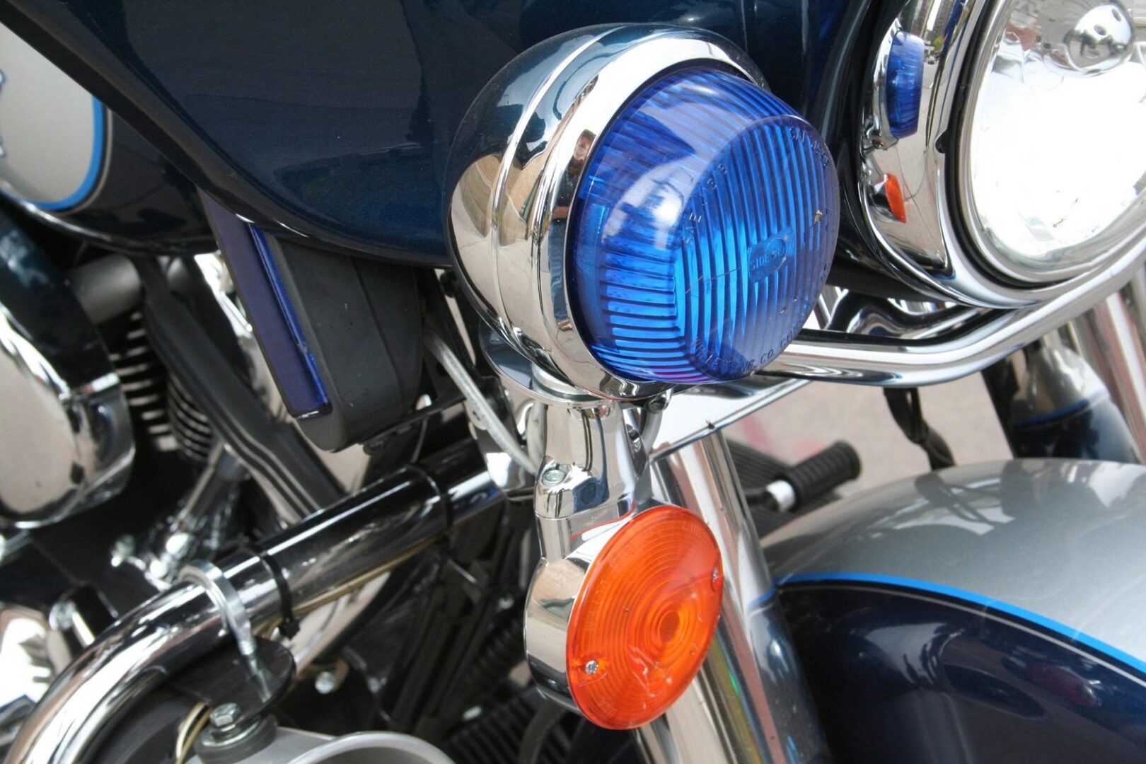 A close up of the front light on a motorcycle.